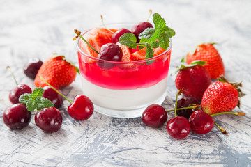 cottage cheese and berry jelly in a glass on a table, selective focus