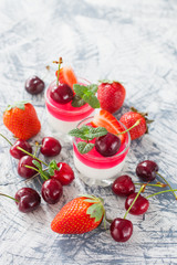 cottage cheese and berry jelly in a glass on a table, selective focus