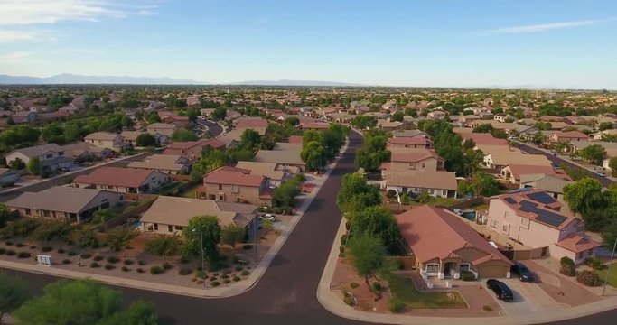 A rising aerial establishing shot of a typical Arizona residential neighborhood. Phoenix suburb.  	