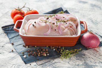 chicken fillet in ware for roasting with vegetables on a table, selective focus