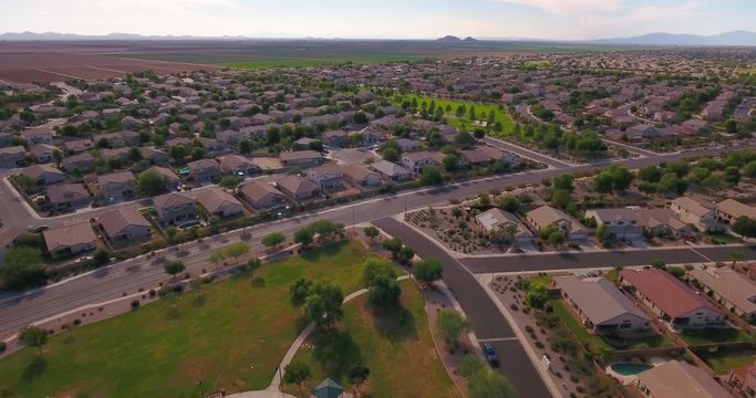 A flyover aerial establishing shot of a typical Arizona residential neighborhood and playground. Phoenix suburb.	 	