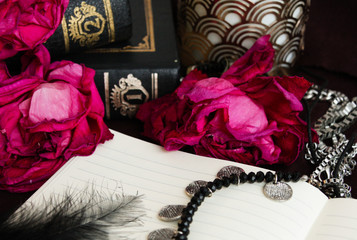 Fototapeta na wymiar Dry roses and pink diary in gothic set-up 1