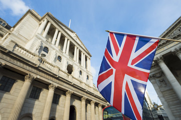 British Union Jack flag flying in front of the Bank of England in the City of London financial center - 127498821