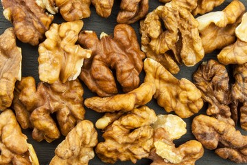Closeup of big shelled walnuts pile. We like walnuts. Advertising on walnuts. Superfoods for the human brain.
