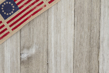 Fototapeta na wymiar USA patriotic old flag on a weathered wood background