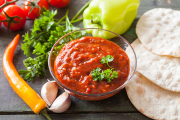 tomato sauce adjika and vegetables on a table, selective focus