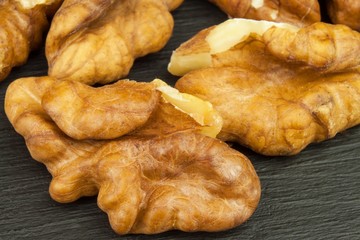 Closeup of big shelled walnuts pile. We like walnuts. Advertising on walnuts. Superfoods for the human brain.
