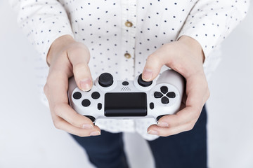 Girl in polka shirt is holding a video game controller