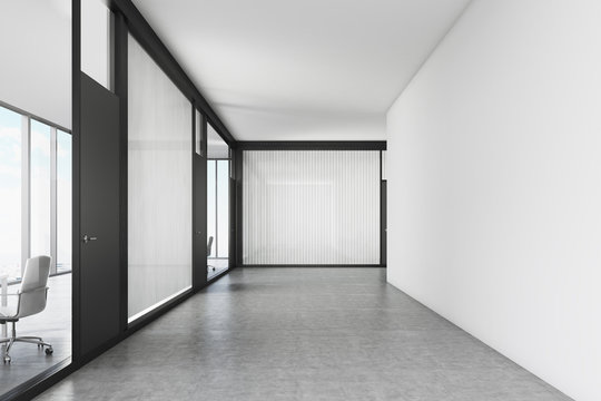 Empty office corridor with a meeting room