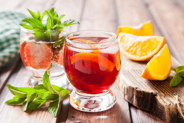 drinks with strawberry and orange in a glass on a table, selective focus