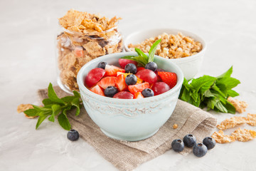 muesli with berries in a bowl on a table, selective focus