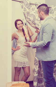 Couple at boutique changing cubicle