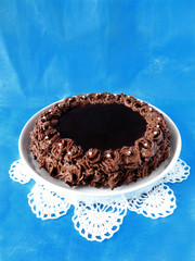 Chocolate cheesecake on a blue background