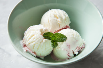 ice cream with strawberry sauce in a bowl on a table, selective focus