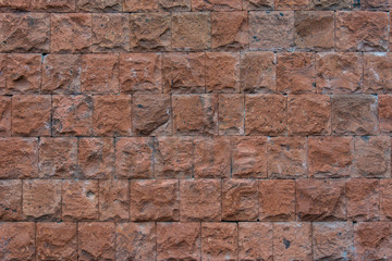 Obraz premium Wall from brown stone. Standard background.