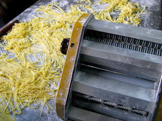 Vintage Metal pasta maker machine with fresh dough.