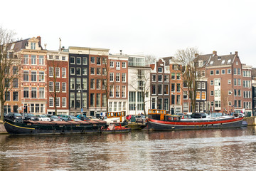 Fototapeta na wymiar Beautiful view of Amsterdam canals with bridge and typical dutch