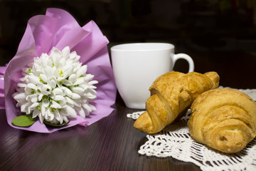 croissants,cup and snowdrops flowers