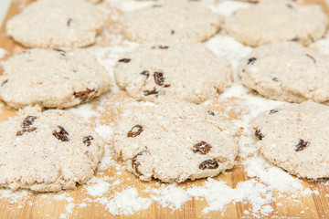 Biscuits with cottage cheese and raisins on the wooden board in the kitchen. Homemade pastries. Christmas tradition baking cookies, cakes and biscuits. Very tasty.