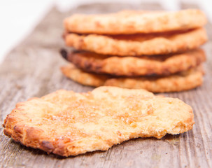 Cookies on wooden background, one with a bite mark