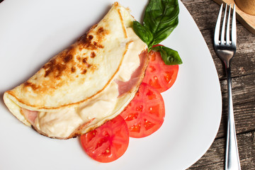 Delicious italian omelette with cheese and ham