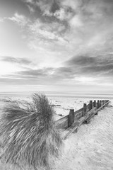 Beautiful beach coastal low tide landscape image at sunrise in b