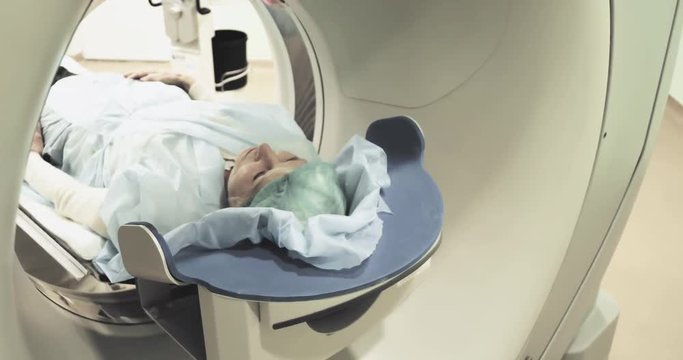 Female patient on CT MRI scanner 4k video. woman moving on computed tomography or magnetic resonance imaging machine  in diagnostic clinic