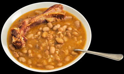 Plateful Of Baked Beans With Smoked Pork Ribs Isolated On Black Background