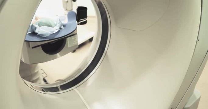 Female patient on CT MRI scanner 4k video. woman moving on computed tomography or magnetic resonance imaging machine  in diagnostic clinic