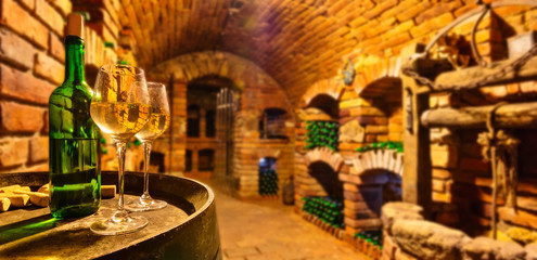 Small wine cellar with bottle and glasses of wine