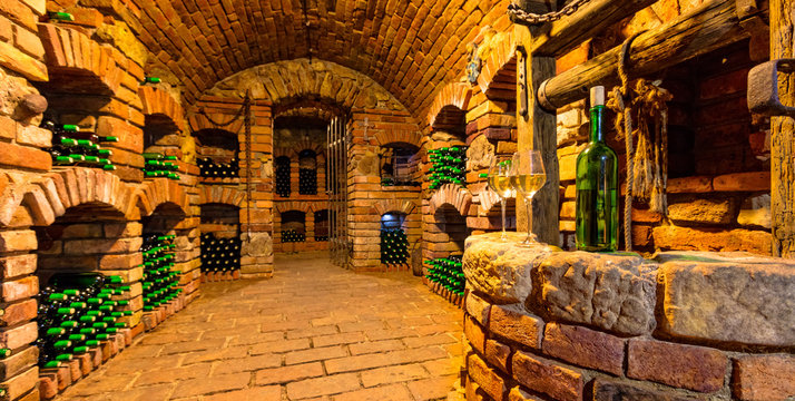 Small wine cellar with bottle and glasses of wine