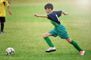 young boy playing soccer