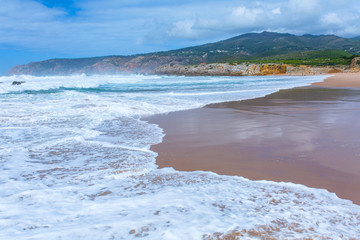 View of Guincho Beach, Cascais, Portugal. Empty beach. No people. Beauty in nature. Waves on the Atlantic ocean. Beautiful landscape.