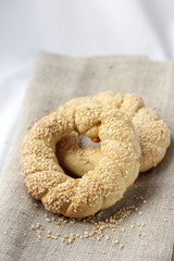 Two homemade bagels with sesame on a gray canvas
