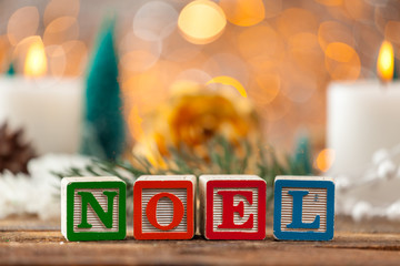 Noel Written With Toy Blocks On Christmas Card Background With C