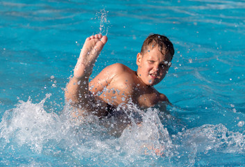 boy swims with a splash in the water park