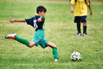 young boy playing soccer - 127521276