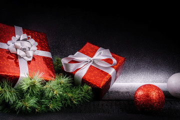 Fototapeta na wymiar red Christmas gifts and decorations on a black wooden background