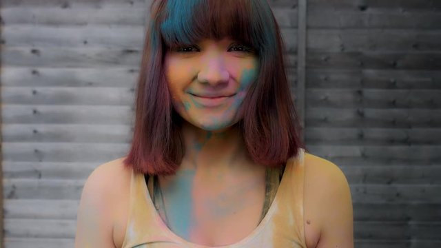 4k Colourful LGBT Shot of a Woman in Holy Powder Smiling at camera