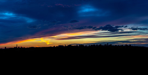Panoramic view of the big city silhouette against the backdrop of incredibly, awesome bright, colored sunset. Kyiv. Ukraine.
