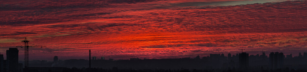 Panoramic view of the city silhouette against the backdrop of incredibly, awesome bright, colored sunset.