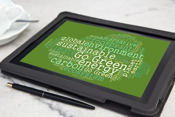 tablet with go green word cloud