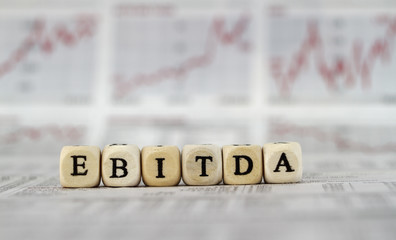 EBITDA word on a business newspaper