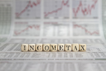 income tax word on a business newspaper