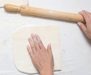 rolling the dough in the kitchen