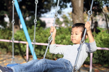 ブランコで遊ぶ小学生(1年生)