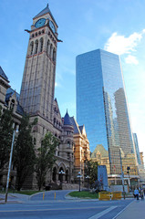 Fototapeta na wymiar Old city hall tower and high-rise.
