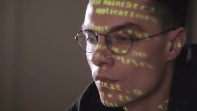 Hackers screen with binary code, data code reflectied in programmer's glasses. HD.