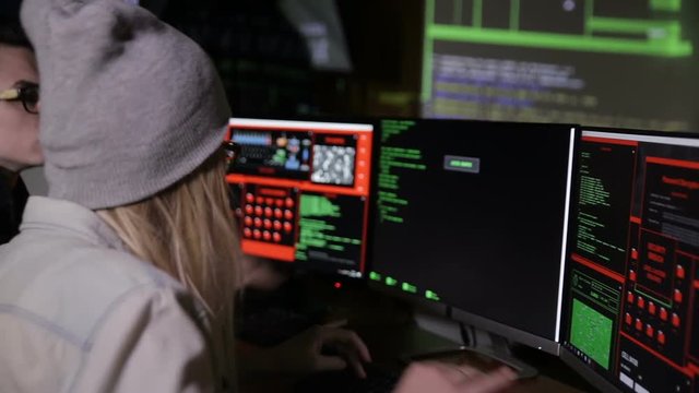 Man and woman working with computer, hacking computer system. HD.