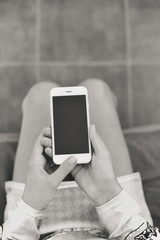 Black and white image closeup of smartphone in the hand on copy space background